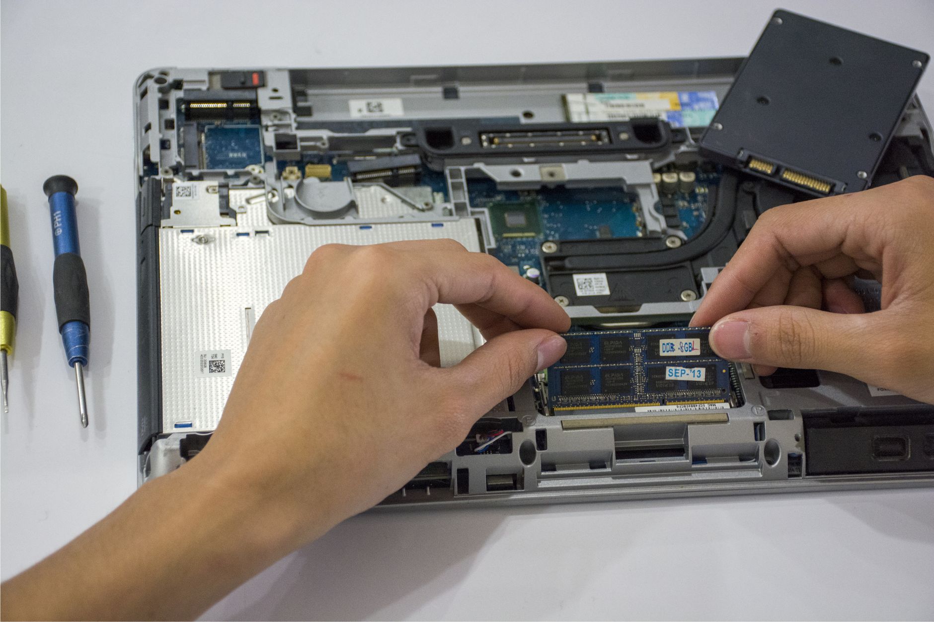 Technician working on the internal components of a laptop