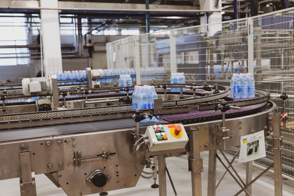 Custom labeled bottled water lined up on a production line
