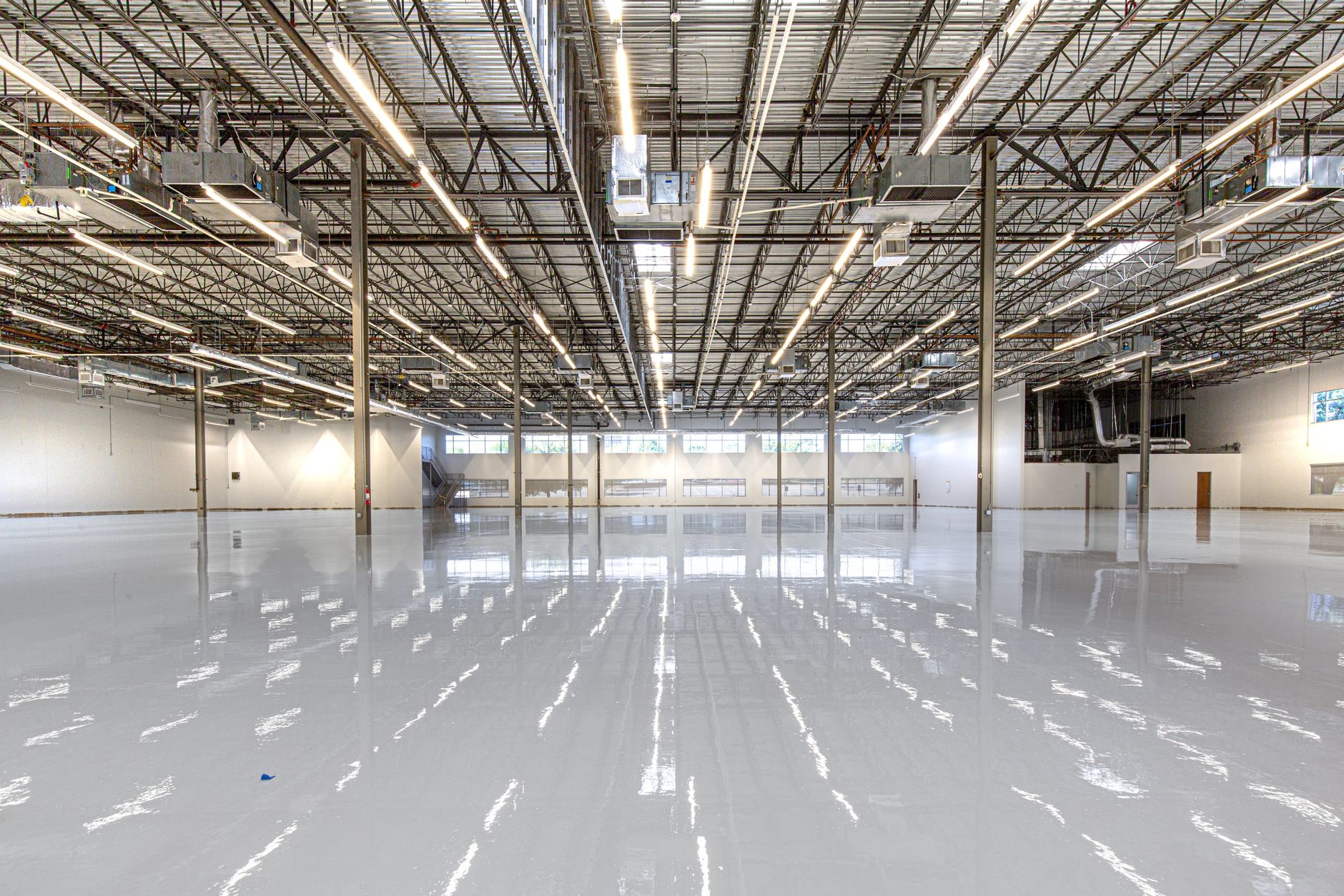 Glossy epoxy floor running through a large industrial facility