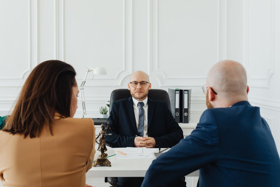 Immigration lawyer consulting with a client in a law office