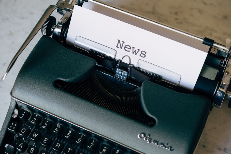 A vintage typewriter with a sheet of paper reading 'News'