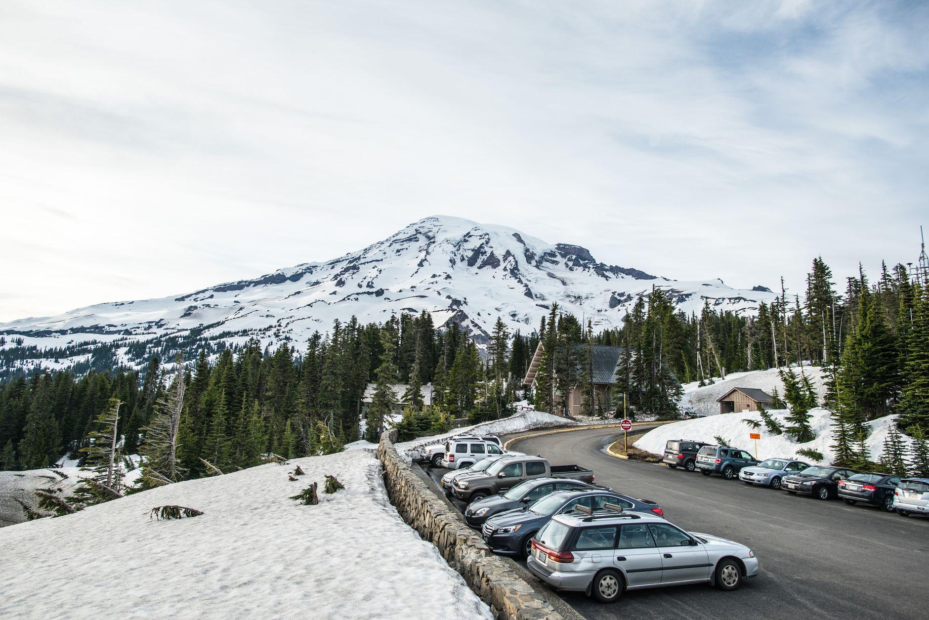Snow-covered mountains rising above forested terrain