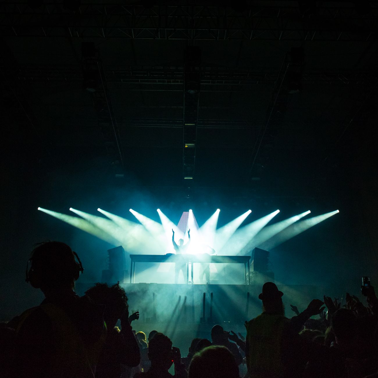 Dimly lit event space with spotlights, representative of past ceremonies