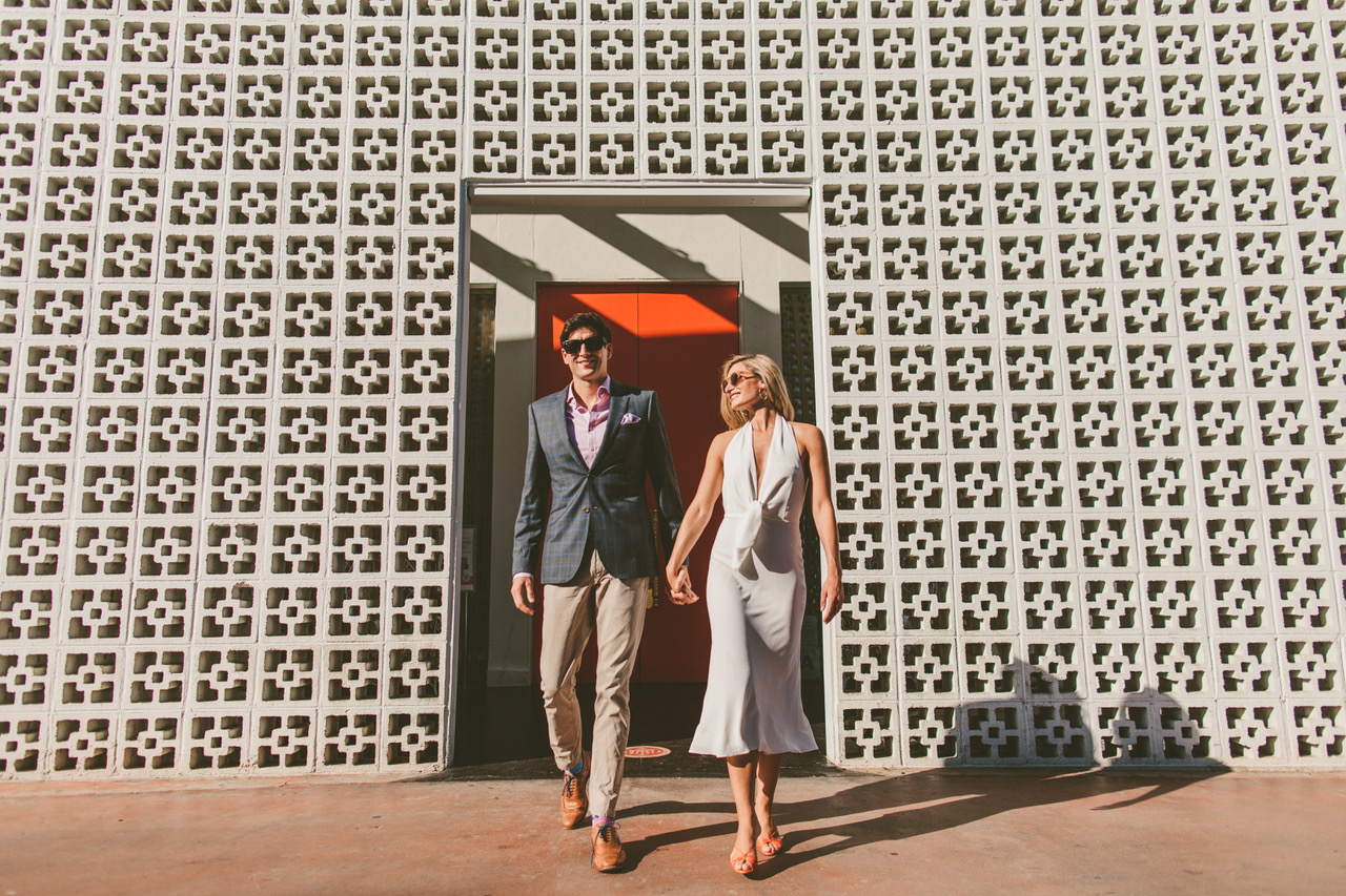 Ryan Horban Photography wedding couple walking through a mid-century breeze-block wall in Palm Springs